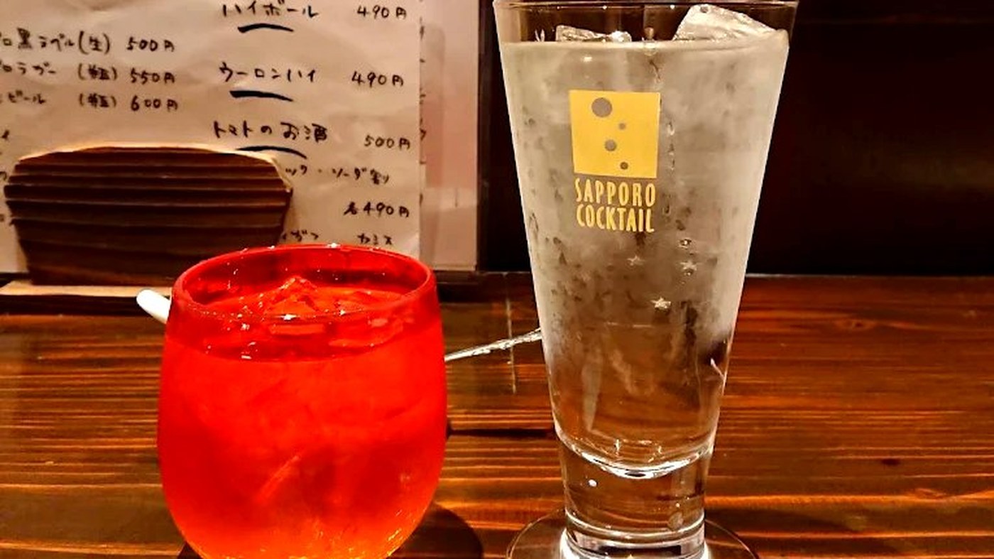 Sake and shochu bottles lined up behind the counter at Danke Izakaya