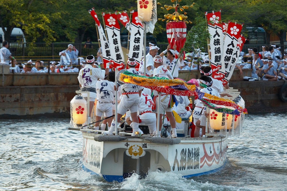 Participants in white costume aboard a Tenjin Matsuri Funa-Togyo boat procession