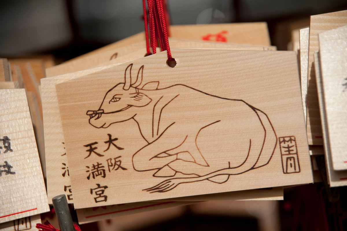 Ema wooden wishing plaques at Osaka Tenmangu Shrine featuring an ox